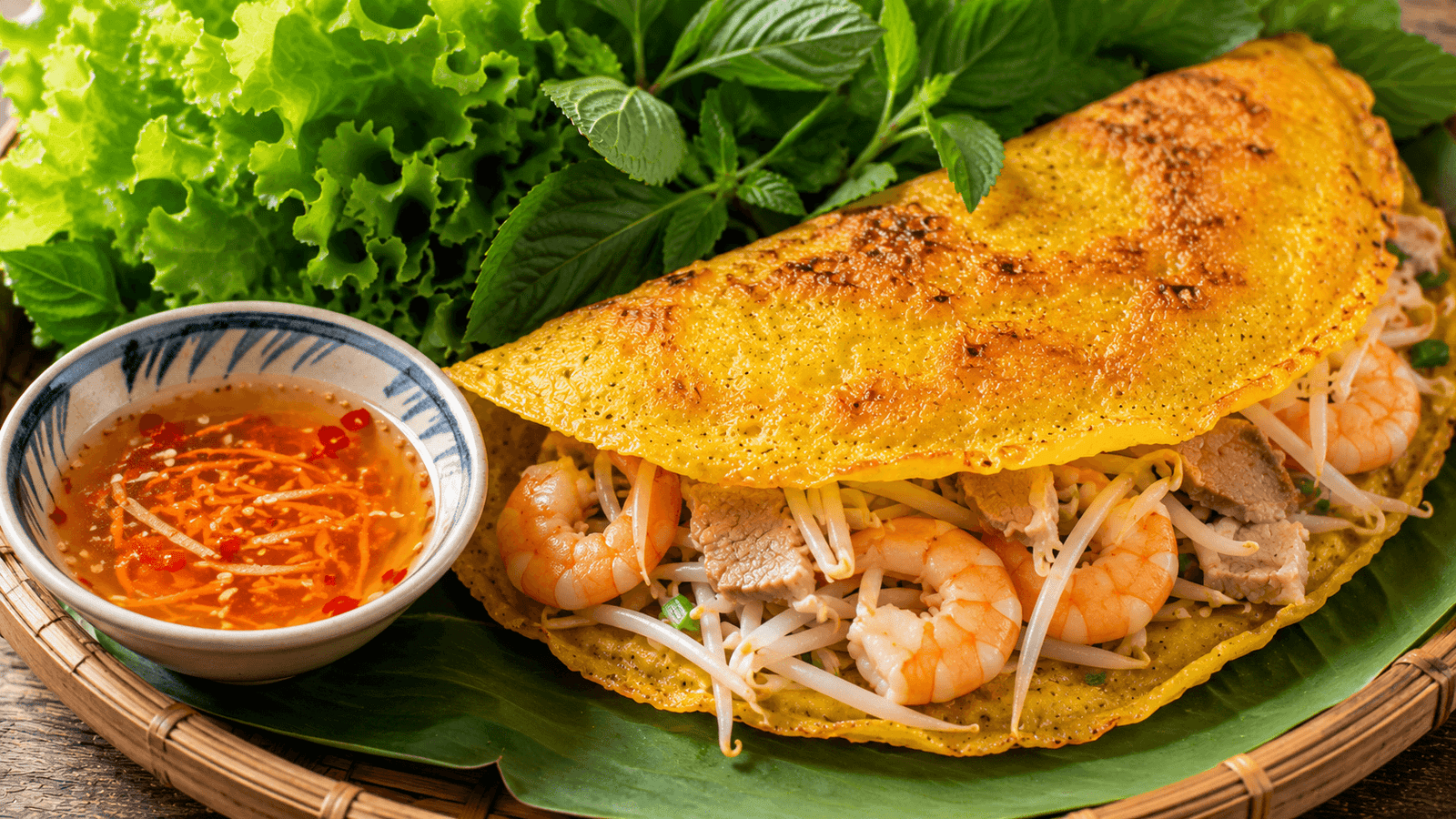 A crispy gluten-free banh xeo rice-flour crepe with shrimp and herbs
